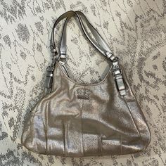 Coach Handbag In Gold/Silver/Champagne. Has A Nice Sheen To It. Three Inside Pockets Incl. One Zippered One. Bottom Shows Scuff Marks And There Are Two Small Stains, Bit Hardly Visible Due To Color And Structure Of Bag. Coach Bags With Silver-tone Hardware For Formal Occasions, Elegant Coach Bags With Silver-tone Hardware, Coach Hobo Bag With Silver-tone Hardware And Double Handle, Coach Hobo Bag With Silver-tone Hardware For Daily Use, Coach Hobo Bag With Silver-tone Hardware For Travel, Chelsea Brown, Vintage Leather Handbag, Fossil Bags, Brown Leather Shoulder Bag