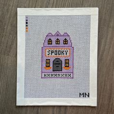 a cross stitch pattern with the words stay home on it and a house in the middle