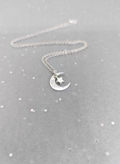 Sterling silver small hammered crescent moon and star necklace. The moon is hammered and then polished and finally a little star added.  All elements are made with recycled 925 sterling silver. This comes on a sterling silver trace chain,  16 (40 cm) or 18 inch (45 cm). Moon measures  1.5cm  Star 6 mm. Larger moon and star necklace. (2 cm) https://www.etsy.com/uk/listing/1037150891/silver-moon-necklace-hammered-crescent All Jewellery arrives  wrapped in tissue in a karmasilver bag.  if you would Sterling Silver Star And Moon Charm Necklaces, Sterling Silver Star Charm Necklace With Moon Charm, Sterling Silver Charm Necklace With Moon And Star, Moon Necklaces, Silver Crescent Charm Necklace With Star, Sterling Silver Crescent Necklace With Star Charm, Crescent Sterling Silver Necklace With Star Charm, Sterling Silver Moon Shaped Necklace With Star Charm, Silver Necklace With Moon Charm And Star Shape