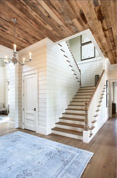 an open floor plan with stairs leading up to the second floor and another room in the background