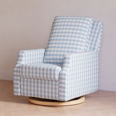 a blue and white checkered chair sitting on top of a hard wood floor next to a wall