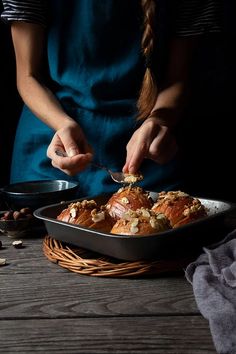 a woman is cutting food in half with a knife