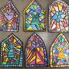 four stained glass windows in different shapes and sizes