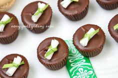 chocolate cupcakes with white frosting and green ribbon