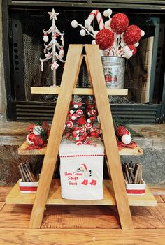 a christmas tree made out of candy canes in front of a fireplace