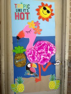 a door decorated with pink flowers and an image of a flamingo holding a pineapple