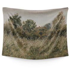 a tapestry hanging on the side of a wall with trees and grass in front of it