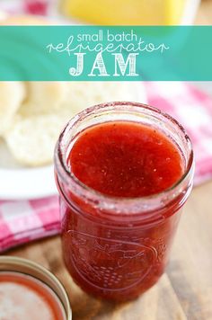 a jar filled with jam sitting on top of a wooden table