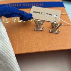 Nwt Louis Vuitton Rhinestones Stud Earrings These Lv Iconic Earrings Bring To Life One Of The Most Recognizable House Signatures And Give It A Modern Update. The Lv Initials Sparkle With A Rhinestone Finish Across The Surface. The Stud Design Makes This Pair Easy To Wear For Both Everyday And More Formal Occasions. Goldstone Color Hardware Rhinestone Insets Lv Initials Stud Closure New With Box, Dust Bag And Ribbon No Trades Please Poshmark Will Authenticate For You Designer Diamond Earrings For Gift, Designer Diamond Earrings For Anniversary, Luxury Bling Earrings For Formal Occasions, Luxury Gold Diamond Earrings Aaa Quality, Luxury Diamond Earrings With Bling, Designer Diamond Evening Earrings, Luxury Aaa Quality Diamond Earrings As Gift, Luxury Aaa Quality Earrings For Everyday Wear, Mens Wedding Bands Silver