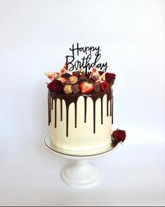 a birthday cake with chocolate and strawberries on top