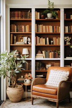 a living room with bookshelves full of books and a chair in the corner