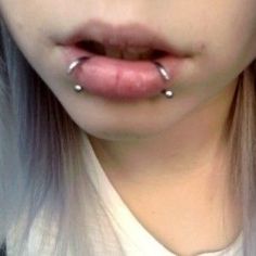 a woman with piercings on her nose