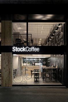 a store front with the words stock coffee on it's glass door at night