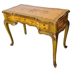 an old wooden table with floral designs painted on the top and drawer at the bottom