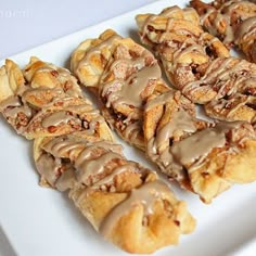 a white plate topped with pastries covered in icing