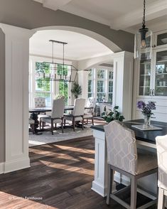 a dining room and kitchen area with wood flooring