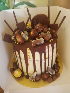 there is a chocolate cake with nuts on the top and icing drizzled over it