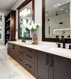 a large bathroom with double sinks and mirrors