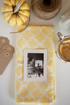 a table topped with two pictures and twine