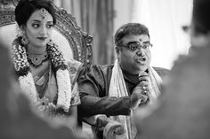 a man sitting next to a woman in front of a mirror