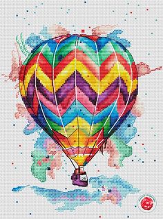 a colorful hot air balloon with watercolor paint splattered on it's side