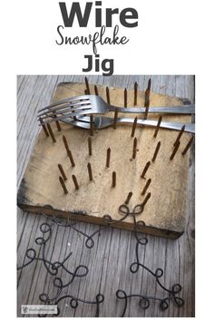 the cover of wire snowflake jig is shown on a wooden board with forks and