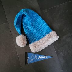 This is a Detroit Lions santa hat for that football lover. It is hand knitted / crochetted with a Lions patch attached to the brim. Crochet Santa Hat, Chunky Hat, Crochet Santa, Hunting Hat, Football Lover, Stocking Hat, Pink Beanies, Unique Hats, Black Beanie