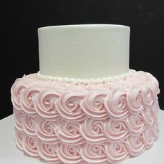 a close up of a cake with icing spirals on the top and bottom