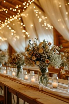 a long table with candles and vases filled with flowers