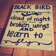 a sign that reads, black bird singing dead of night take these broken wings and learn to fly