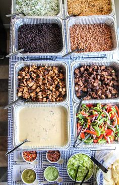 a table topped with trays filled with different types of food and dips on top of it