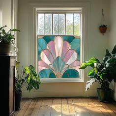 a stained glass window in the corner of a room with potted plants