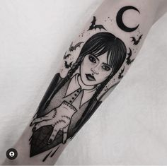 a woman's arm with a black and white tattoo design on the left forearm