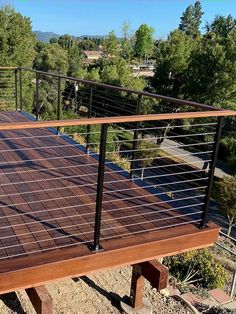 a wooden deck with metal rails and railings