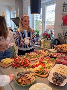 people standing around a table filled with food