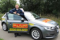 a man sitting on top of a car with a sign that says bill plant fire