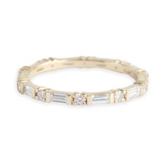 an 18k gold band with baguettes and diamonds