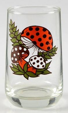 a close up of a glass with a ladybug design on it's side