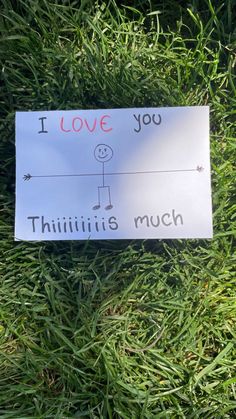 a sign on the grass that says i love you, thiniii's much