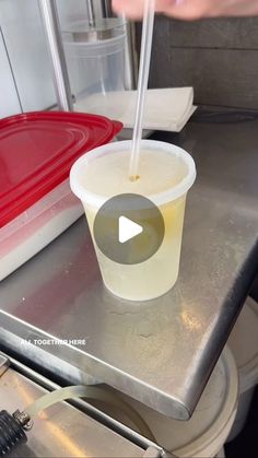 a plastic cup with a straw sticking out of it