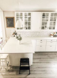 a kitchen with white cabinets and an island