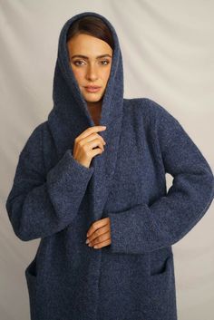 Wrap yourself in the warmth, comfort, and style of the Belen Alpaca Long Hooded Cardigan, a versatile knitwear piece designed to keep you warm and stylish throughout the seasons. Crafted from a luxurious alpaca blend, this cardigan/coat with a hood is elegant and sophisticated, making it perfect for both casual and dressier occasions. - Luxurious Alpaca Blend.- Fashionable and elegant design, the hood adds extra warmth and protection.- Practical pockets.- Versatile length that flatters all body