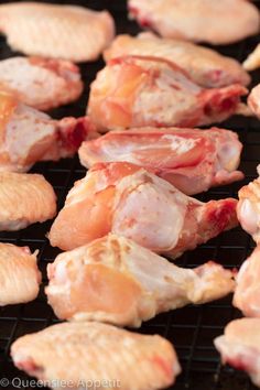 raw chicken wings on a grill being cooked