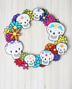 a wreath made out of paper with skulls and flowers