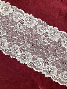 white lace on red fabric with flowers