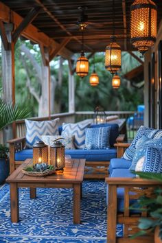 an outdoor living area with blue furniture and lanterns