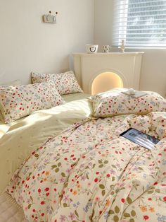 a bed with floral sheets and pillows in a bedroom