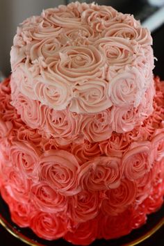 two tiered cake with pink frosting roses on top