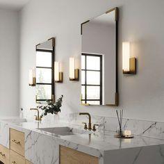 a bathroom with marble counter tops and double sinks in front of three mirrors on the wall