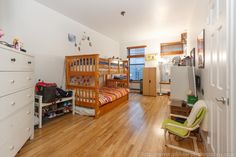 a bedroom with bunk beds, dressers and other items on the floor in it